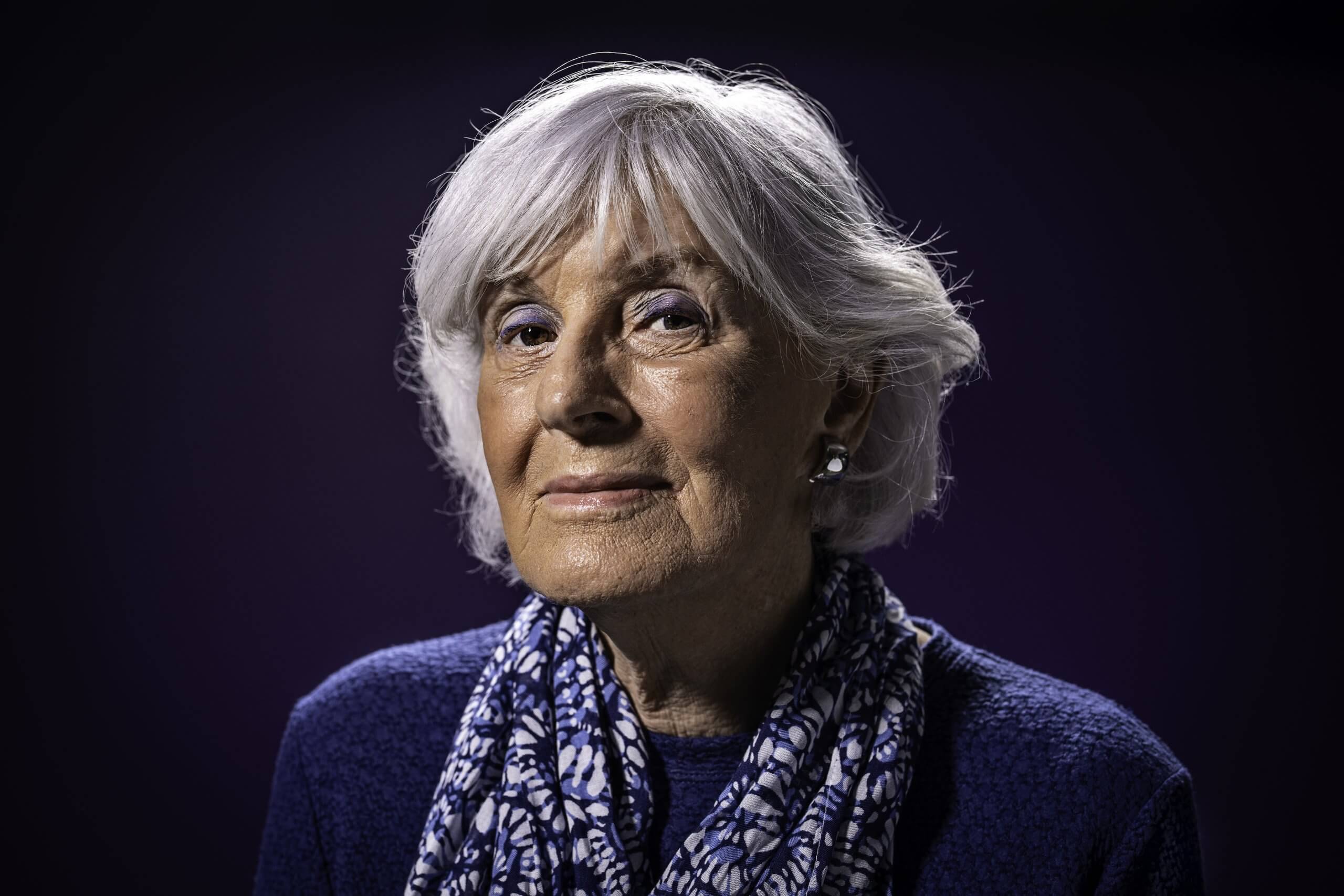 Portrait of an older woman against a dark background