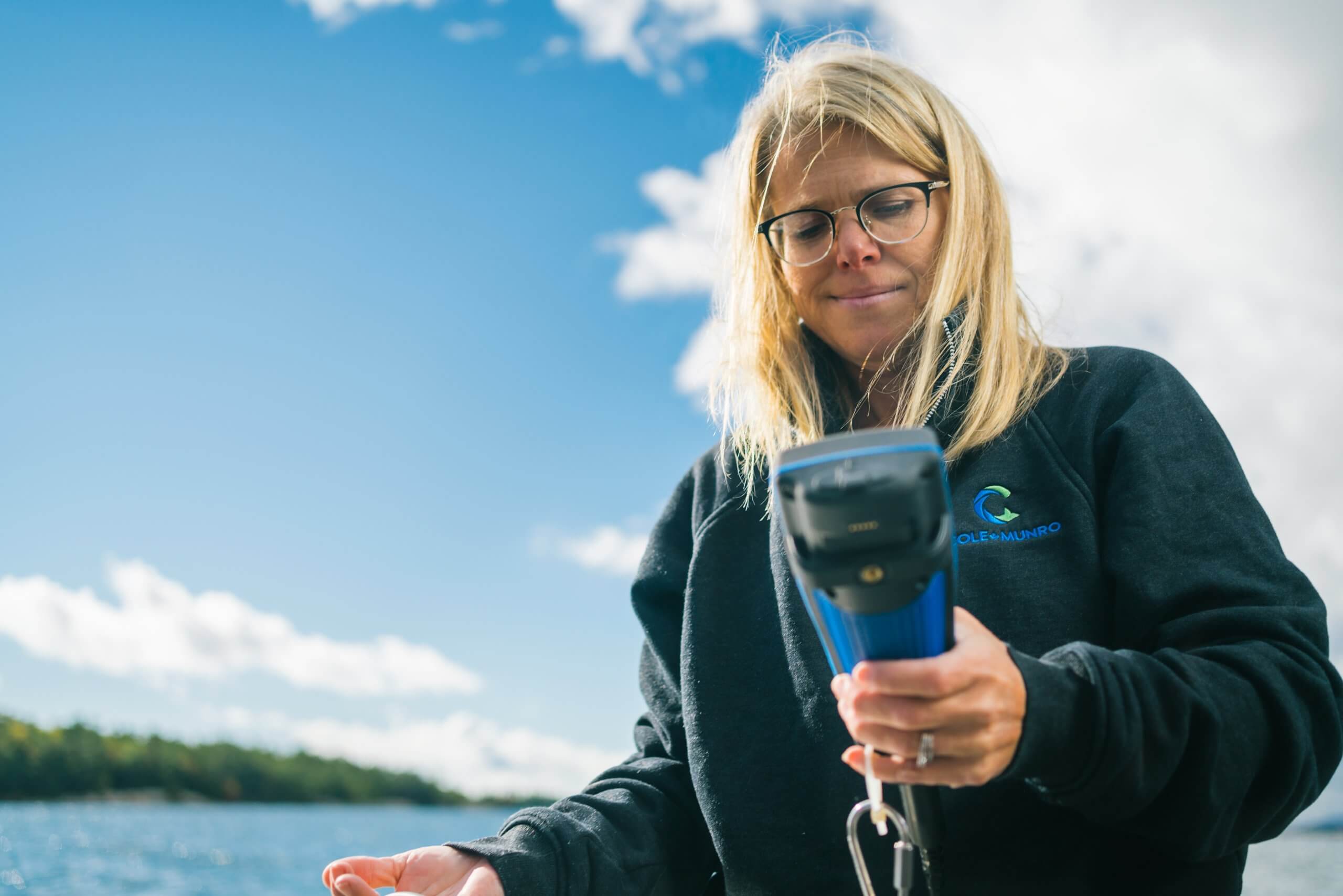 Woman using a handheld device at a fish farm