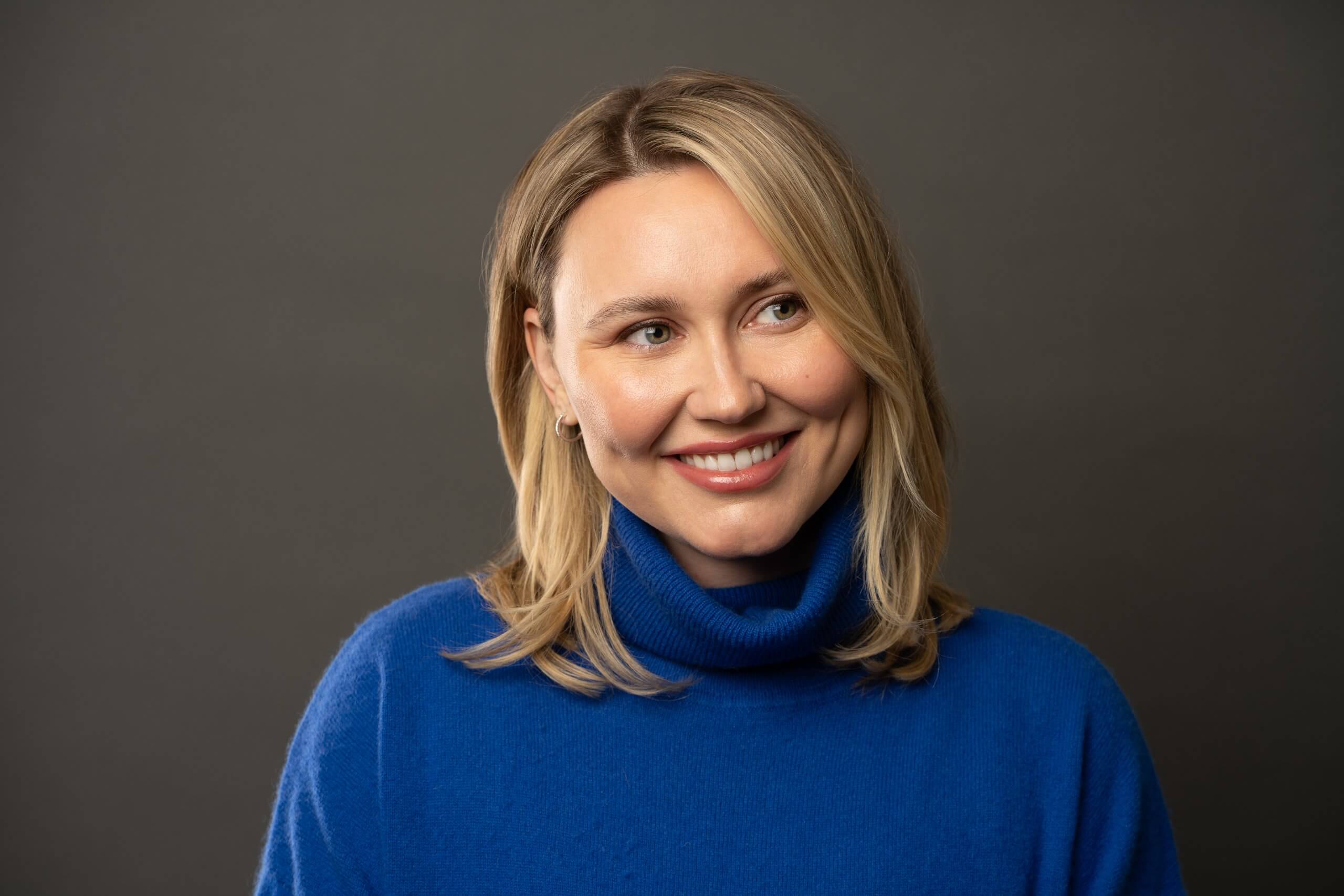 Portrait of a smiling woman in a blue sweater