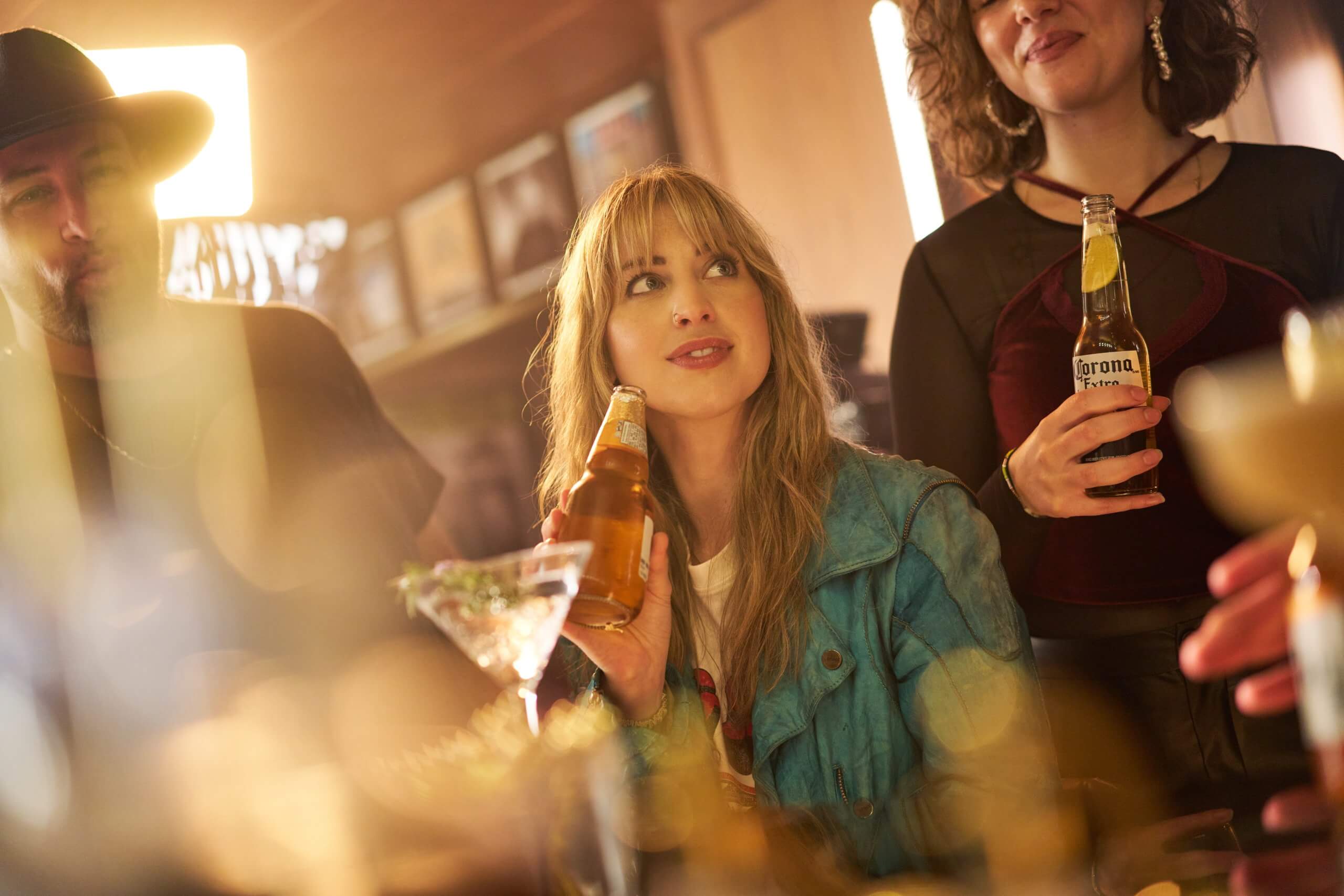 Friends sharing drinks and laughing in a bar