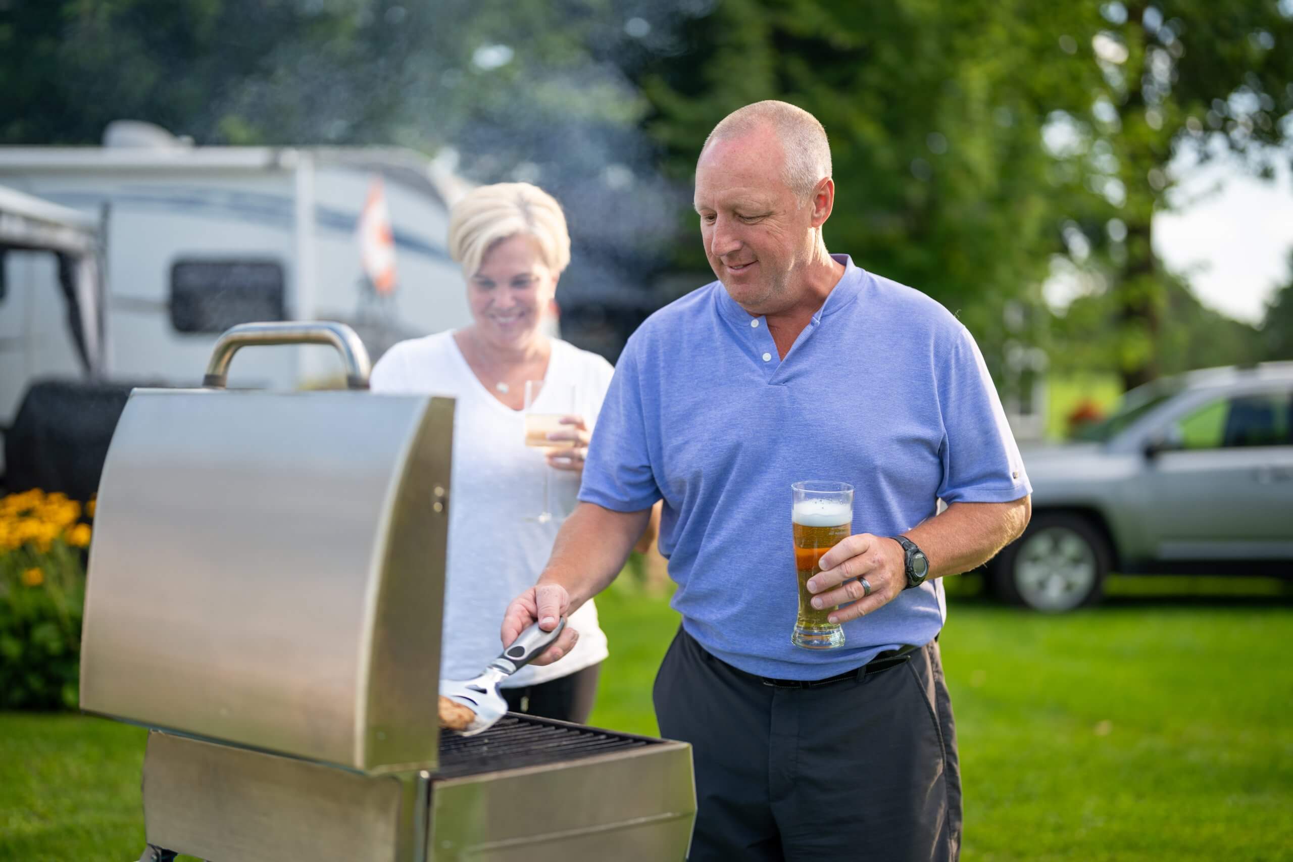 Couple barbecuing at a campsite