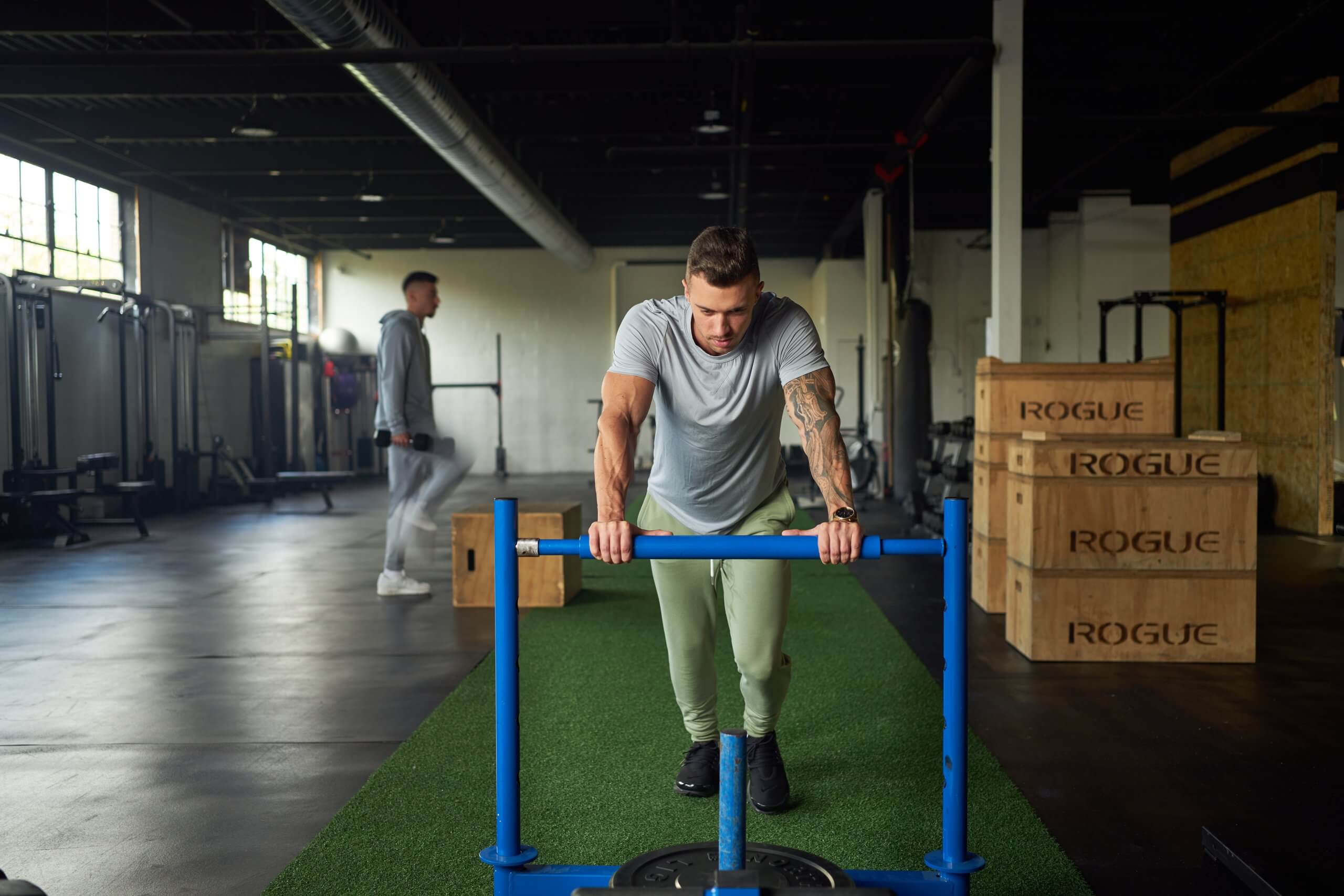Man training with a sled in a gym