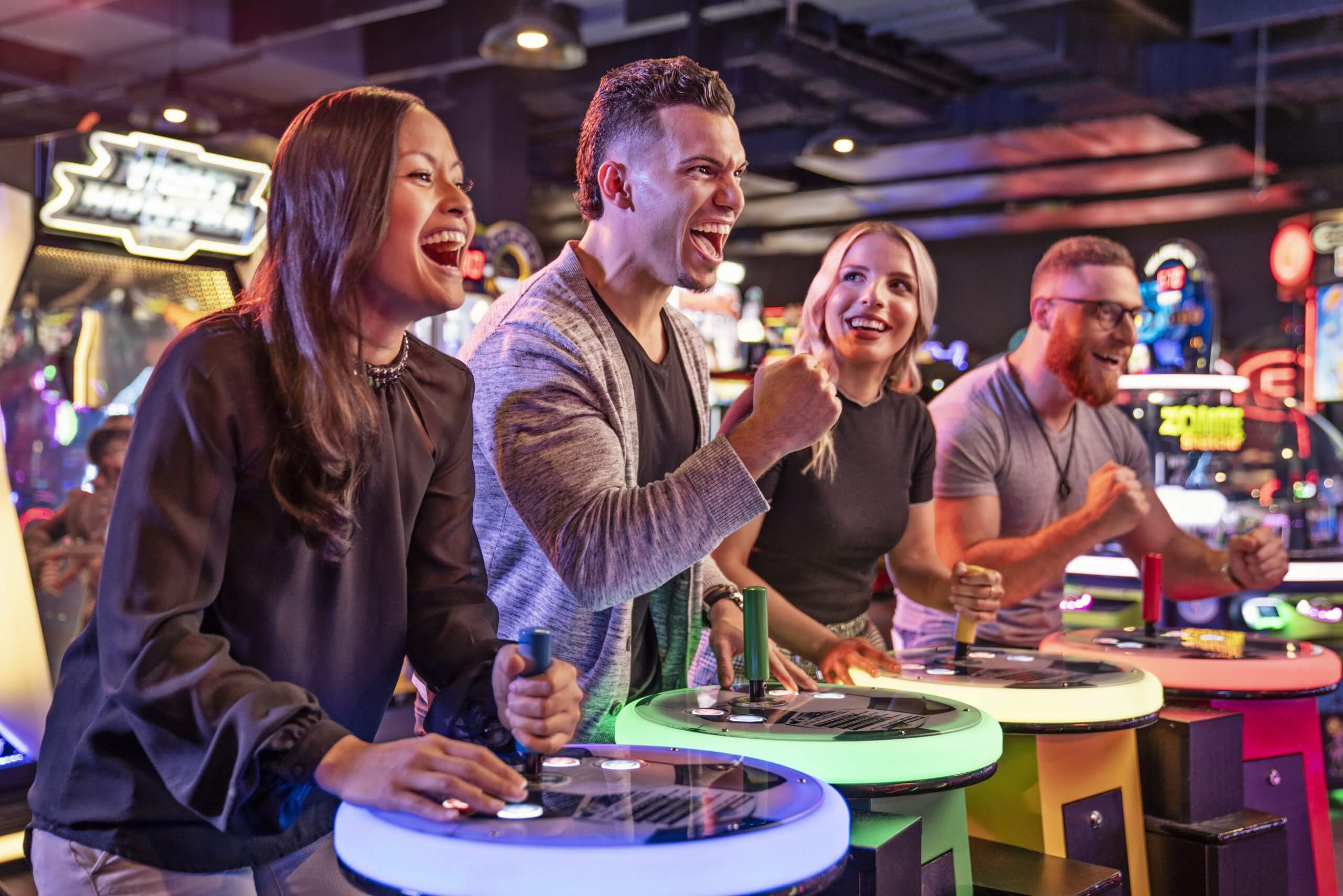 Friends cheering at an arcade game