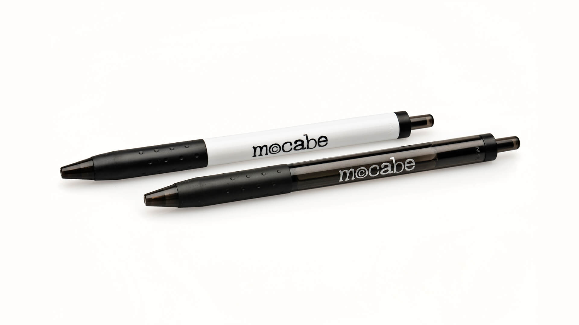 Two McCabe branded pens on white