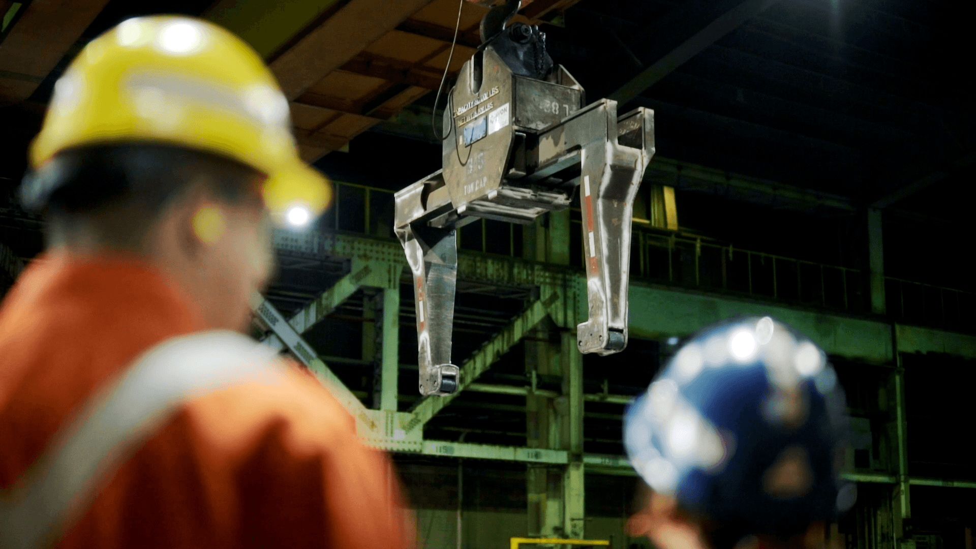 Worker in a hard hat and safety gear at a steel plant